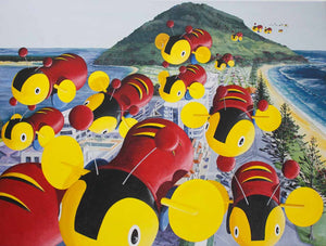 Looking from above at the New Zealand toy, Buzzy Bee ,in a swarm flying around Mount Maunganui and over the buildings at Main Beach.  The Mount is in the background and you can see Pilot Bay on the left and the Main Beach o n the right